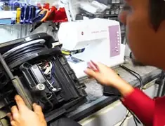 Vacuum repair technician servicing internal components on a workbench in Reno, NV