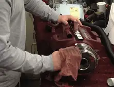 Vacuum repair technician cleaning and servicing a vacuum motor in Reno, NV