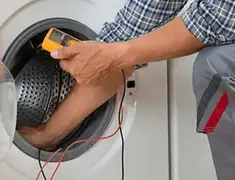 Washing machine repair technician testing a front-load washer with diagnostic tools in Reno, NV